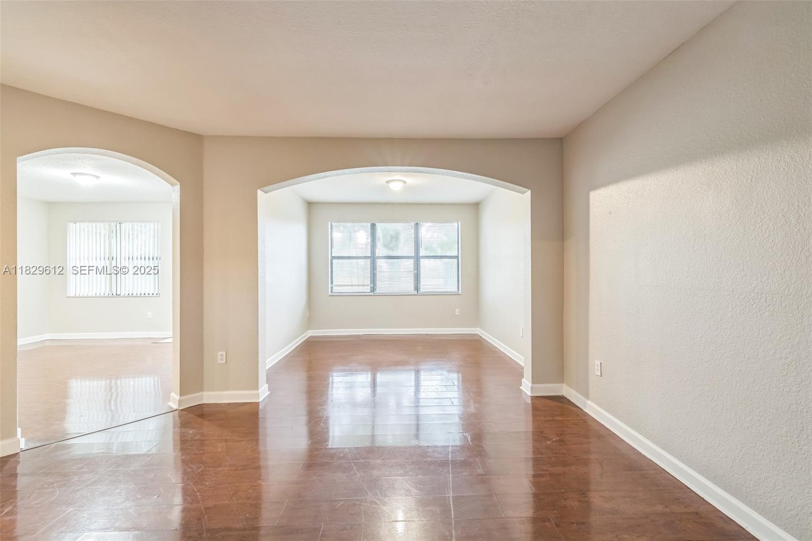 11266 Southwest 236 Lane Homestead, FL 33032 - Photo 11 of 32 wooden floor in an empty room with a window