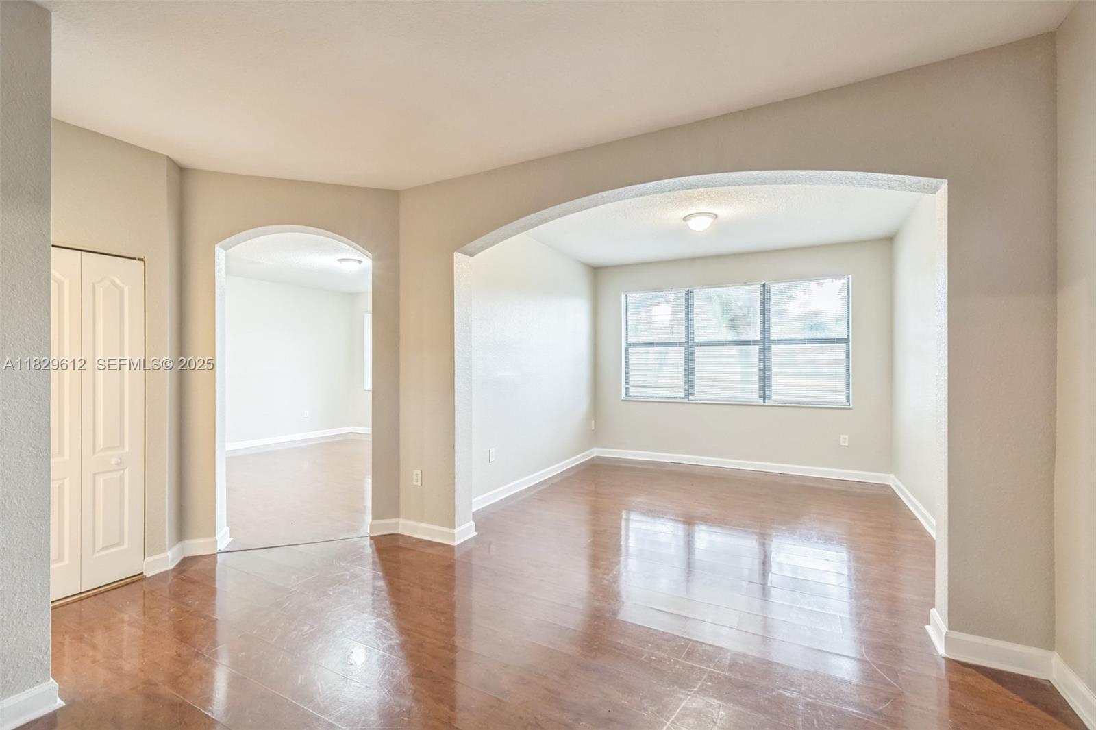 11266 Southwest 236 Lane Homestead, FL 33032 - Photo 12 of 32 an empty room with wooden floor and windows