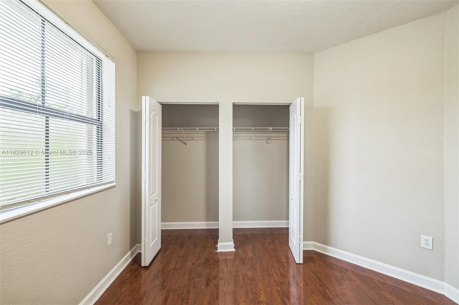 11266 Southwest 236 Lane Homestead, FL 33032 - Photo 15 of 32 an empty room with wooden floor and windows