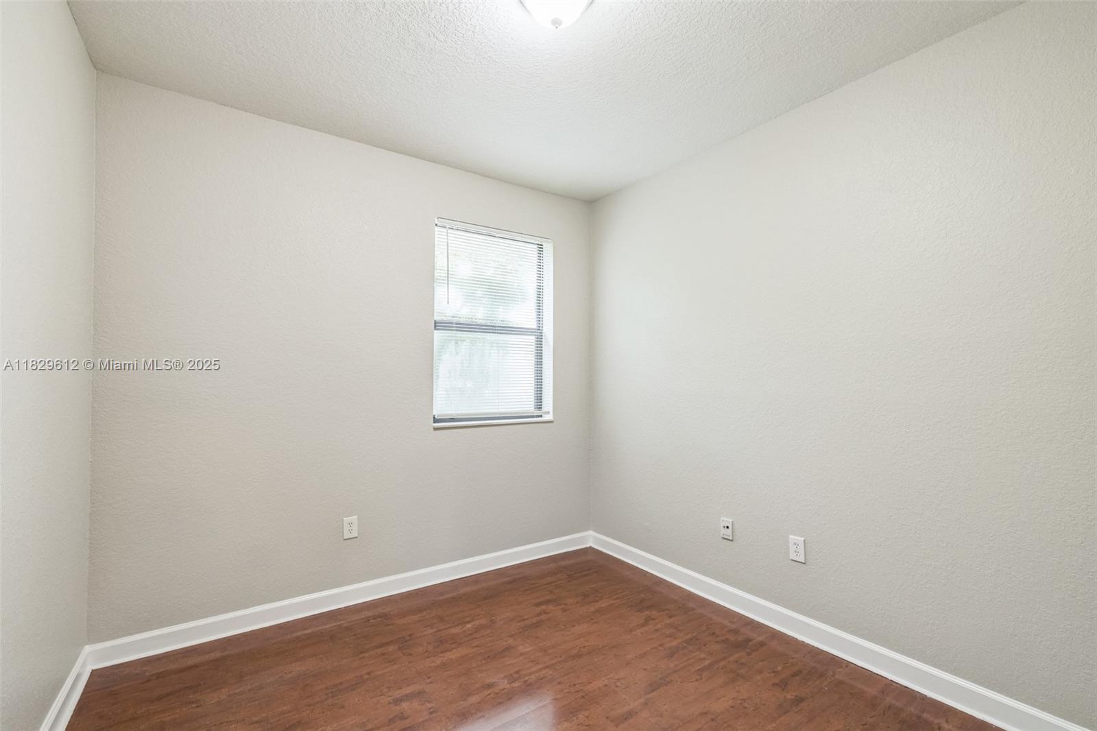 11266 Southwest 236 Lane Homestead, FL 33032 - Photo 18 of 32 an empty room with a window