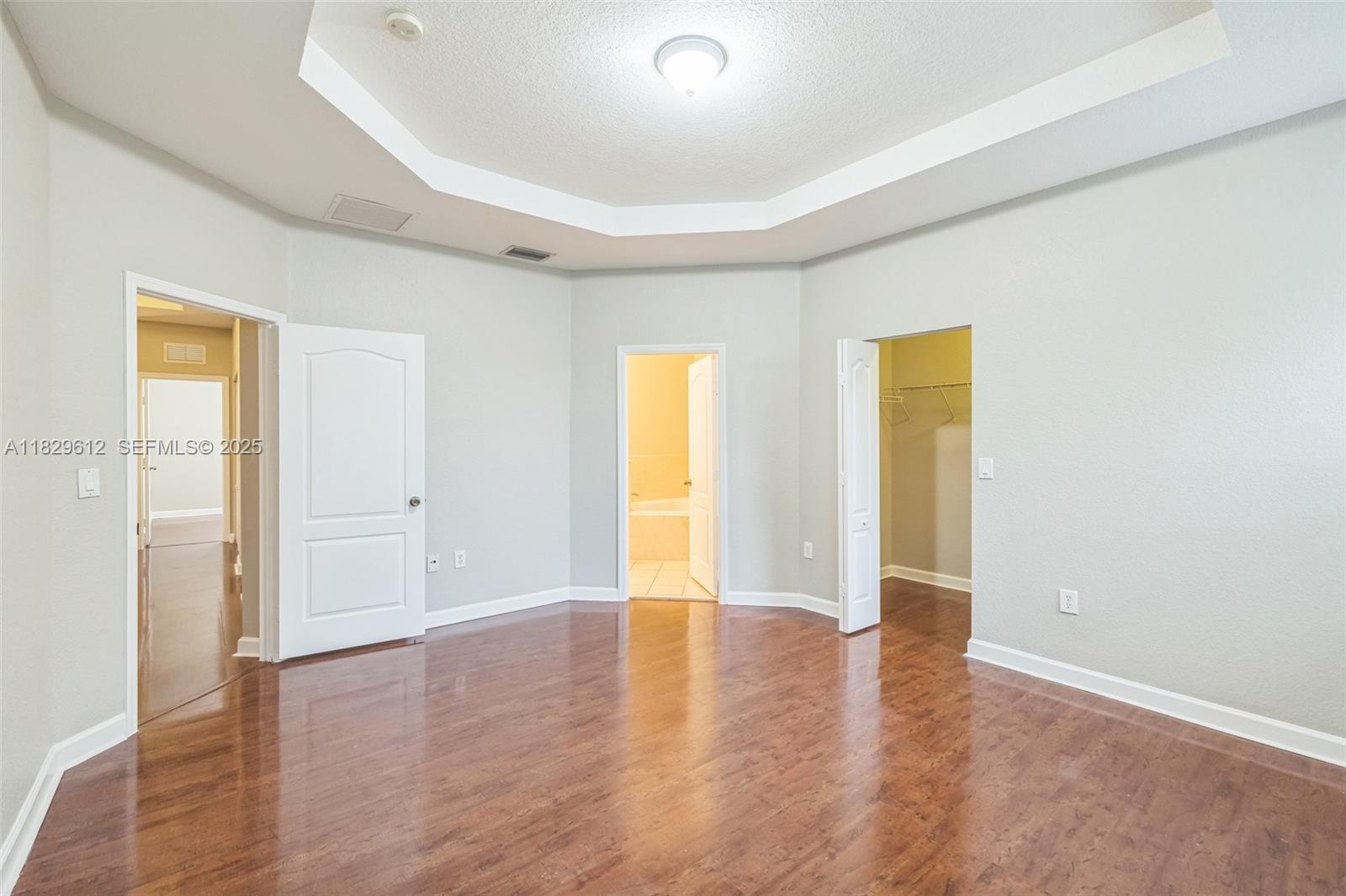 11266 Southwest 236 Lane Homestead, FL 33032 - Photo 22 of 32 a view of an empty room with wooden floor and a window