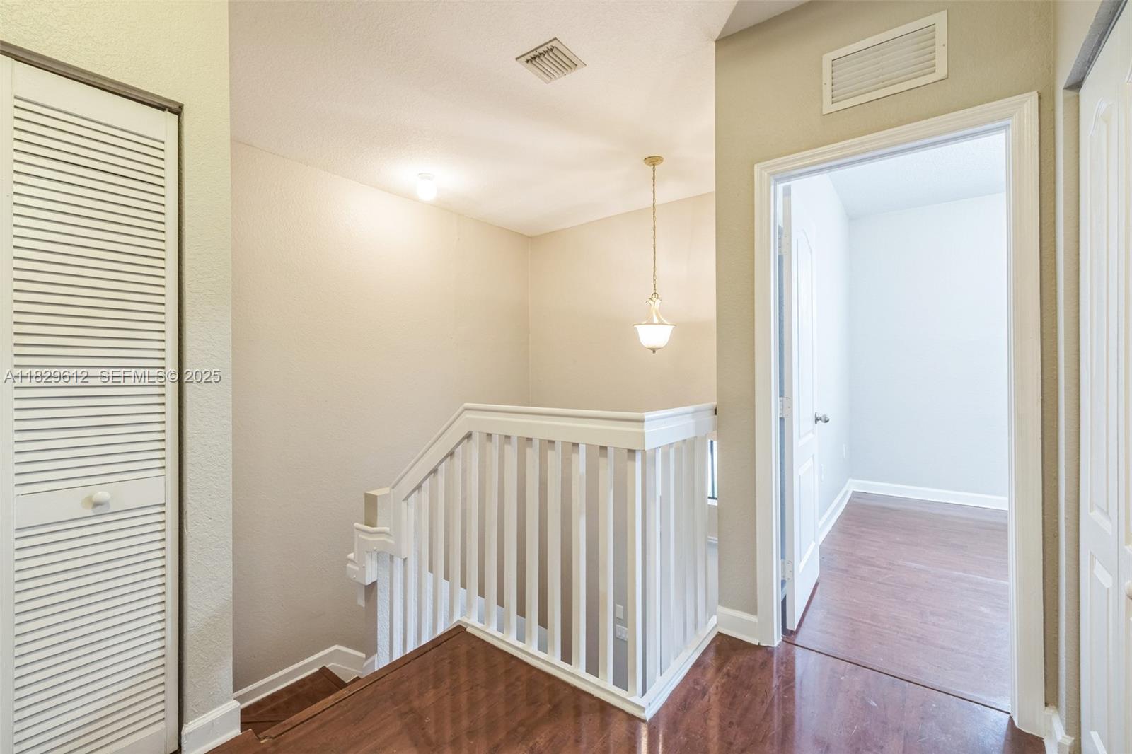 11266 Southwest 236 Lane Homestead, FL 33032 - Photo 24 of 32 a view of a hallway with wooden floor