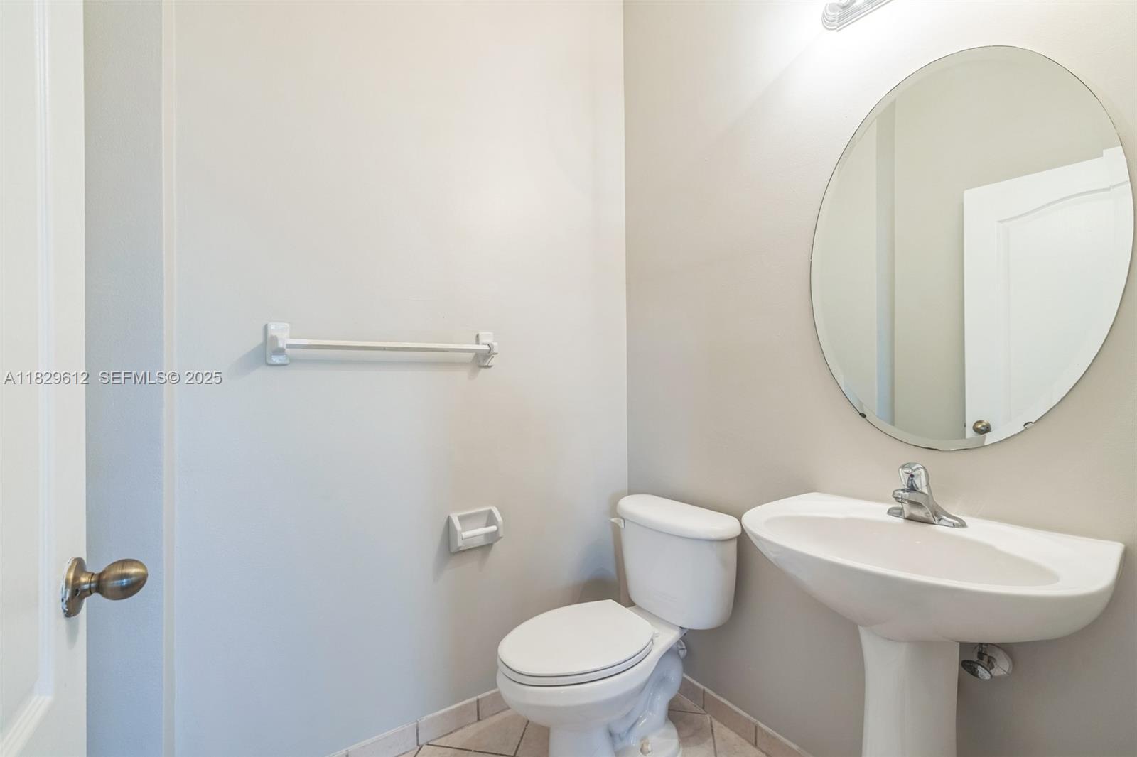 11266 Southwest 236 Lane Homestead, FL 33032 - Photo 30 of 32 a bathroom with a sink mirror and toilet