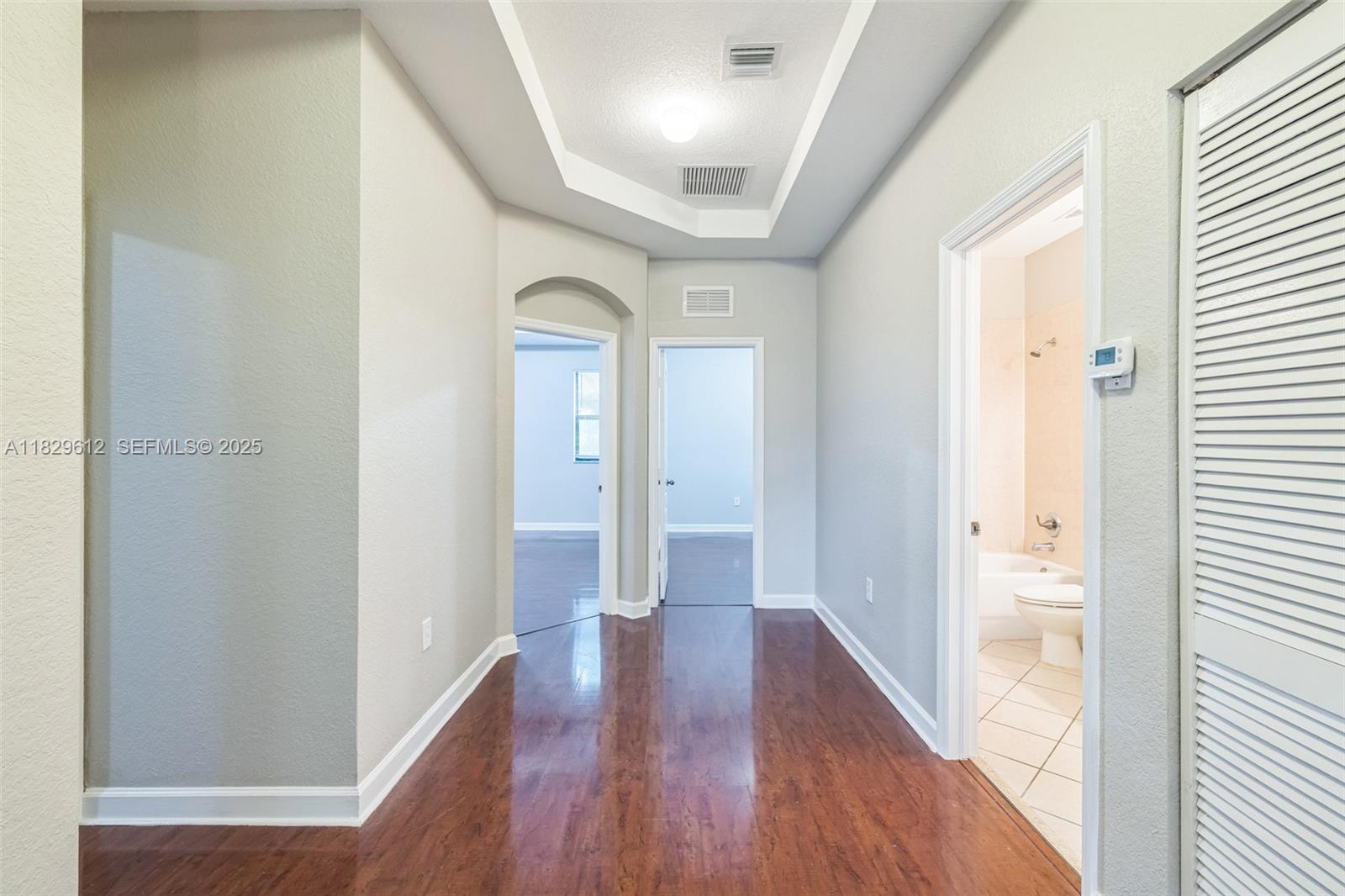11266 Southwest 236 Lane Homestead, FL 33032 - Photo 6 of 32 a view of a hallway with wooden floor