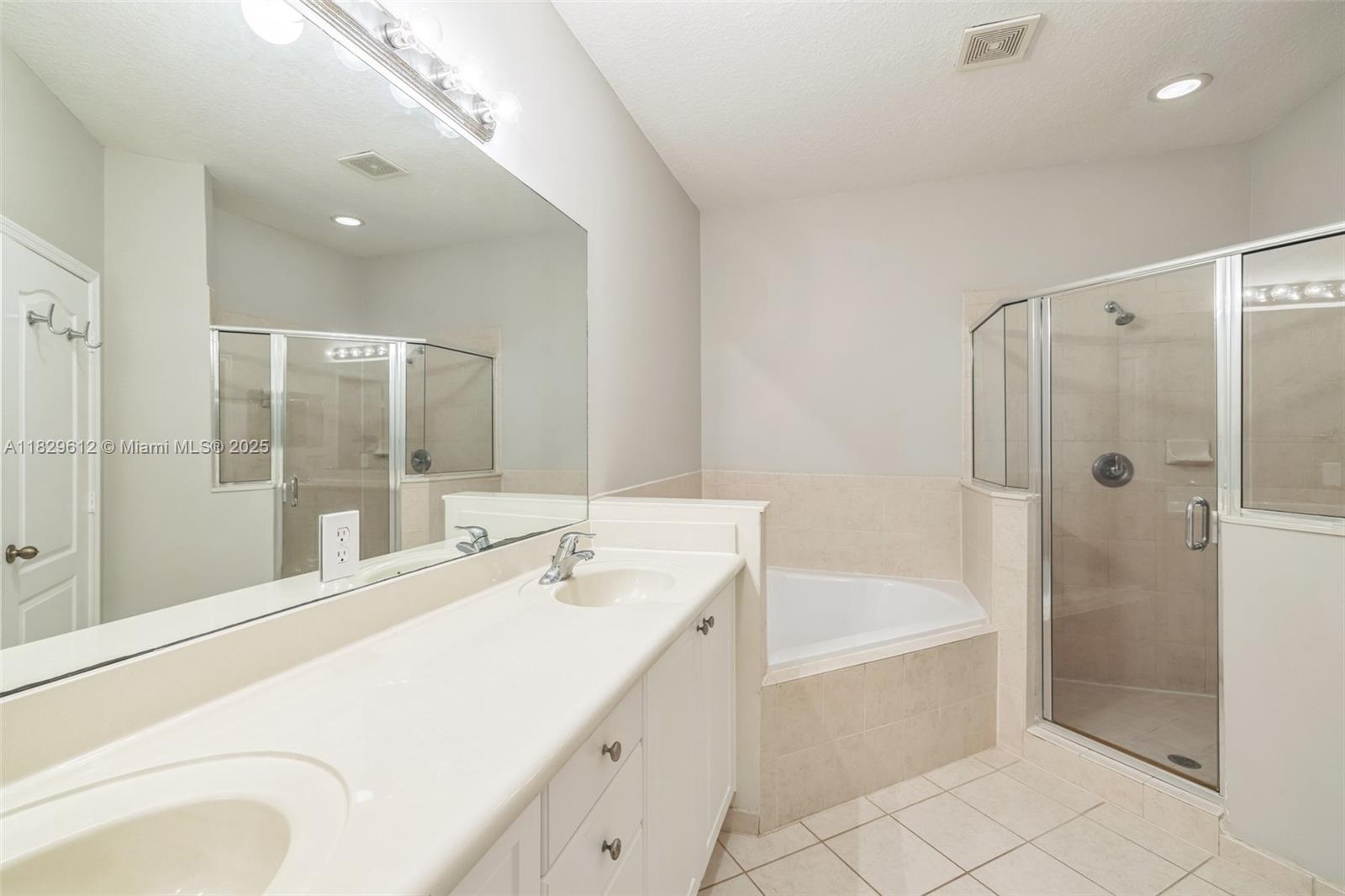 11266 Southwest 236 Lane Homestead, FL 33032 - Photo 8 of 32 a bathroom with a tub sink shower and mirror