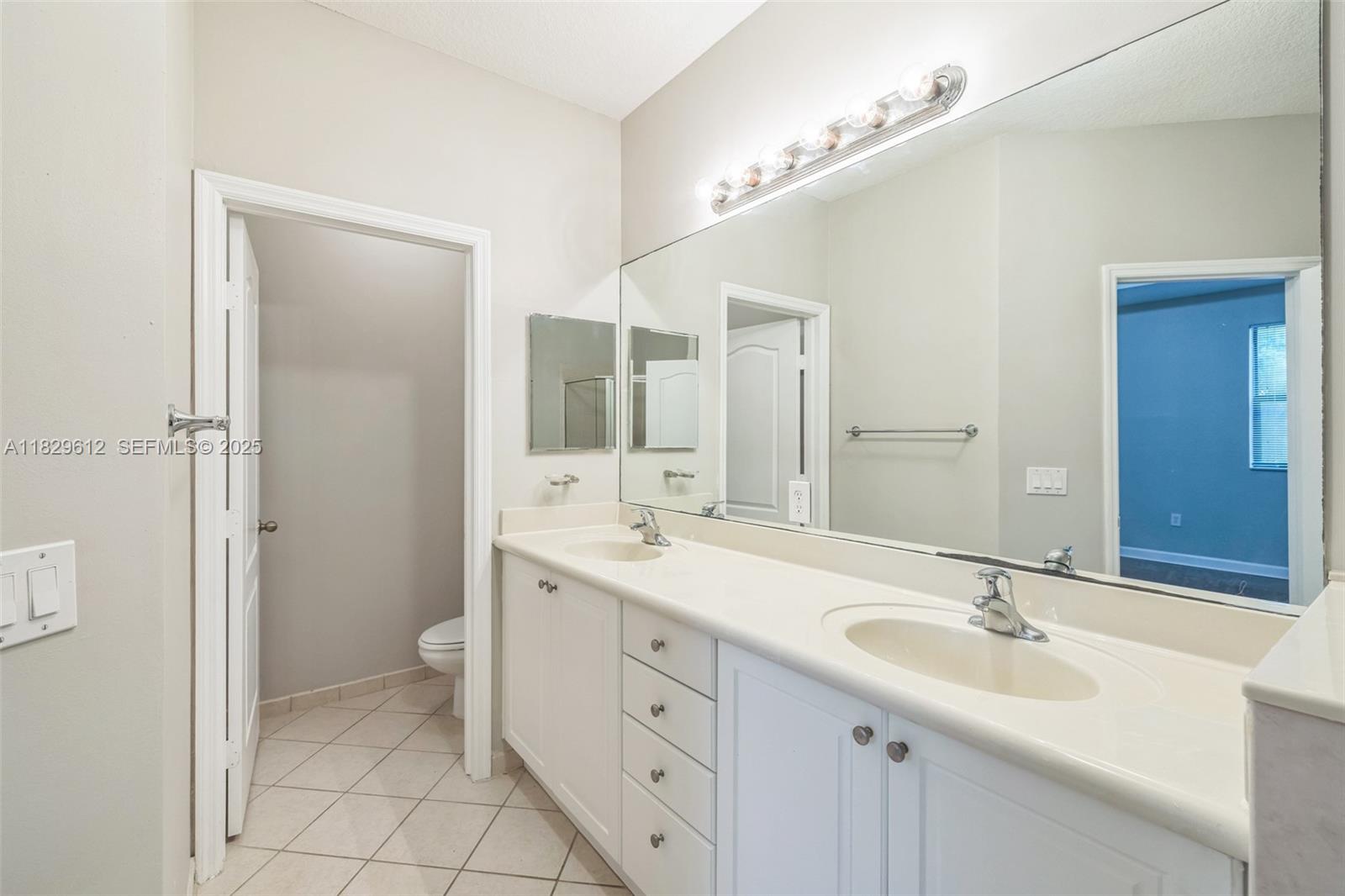 11266 Southwest 236 Lane Homestead, FL 33032 - Photo 9 of 32 a bathroom with a sink and a mirror