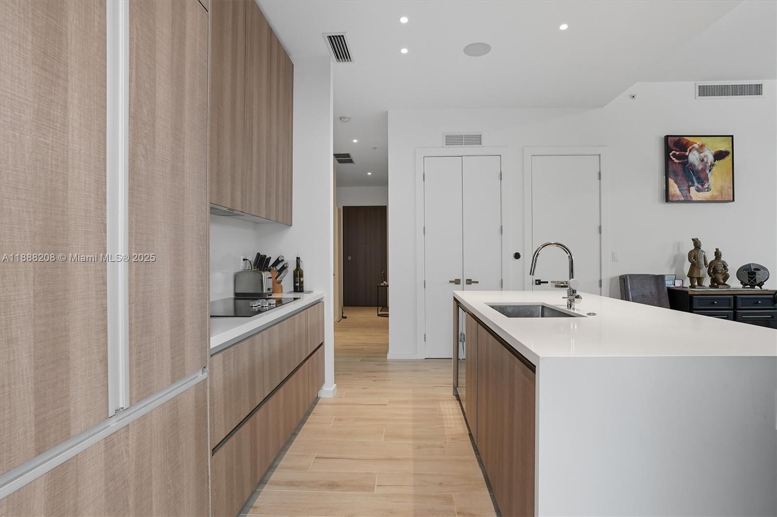3156 Southwest 27th Avenue, Unit 203 Miami, FL 33133 - Photo 12 of 34 a kitchen with sink a microwave and cabinets