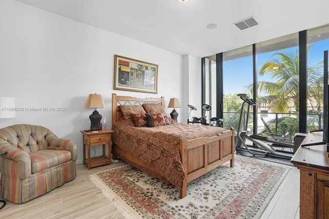 a bedroom with a bed and glass window