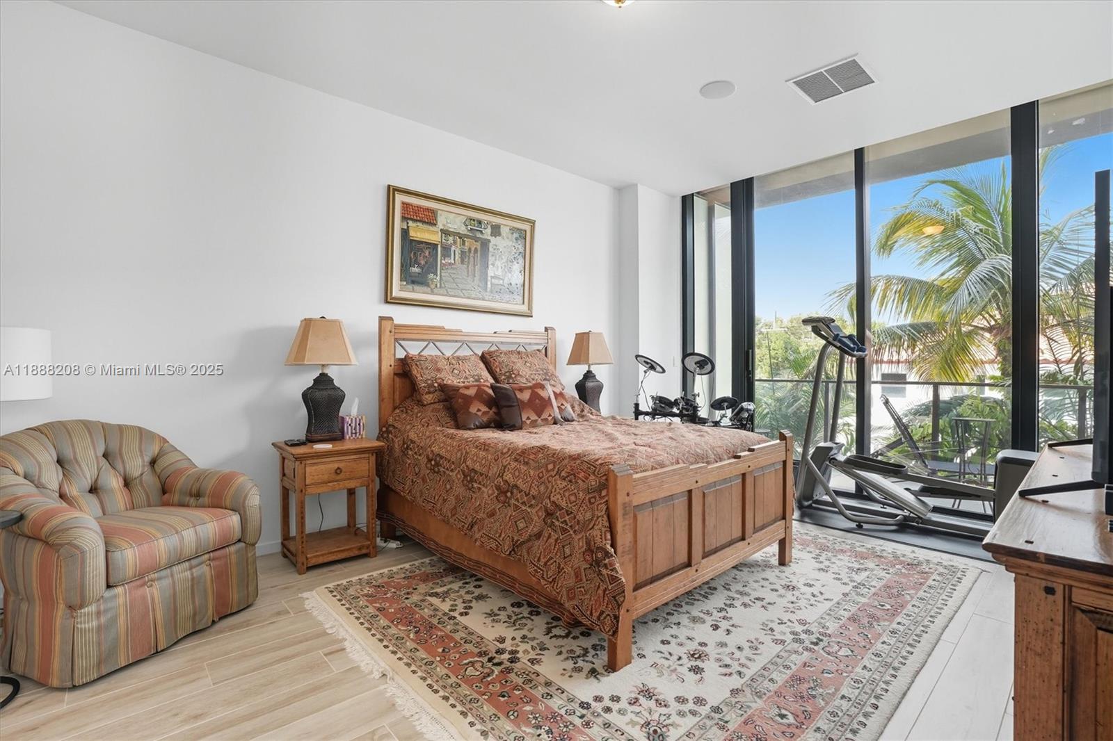 3156 Southwest 27th Avenue, Unit 203 Miami, FL 33133 - Photo 14 of 34 a bedroom with a bed and glass window