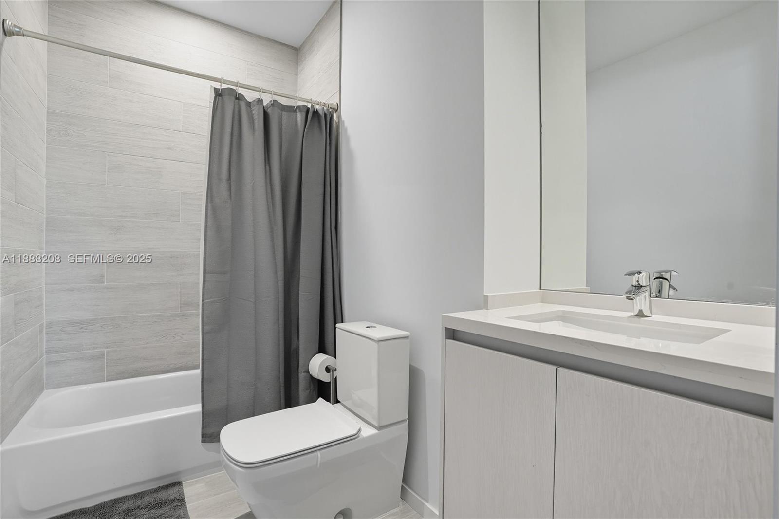 3156 Southwest 27th Avenue, Unit 203 Miami, FL 33133 - Photo 20 of 34 a bathroom with a sink a toilet and shower