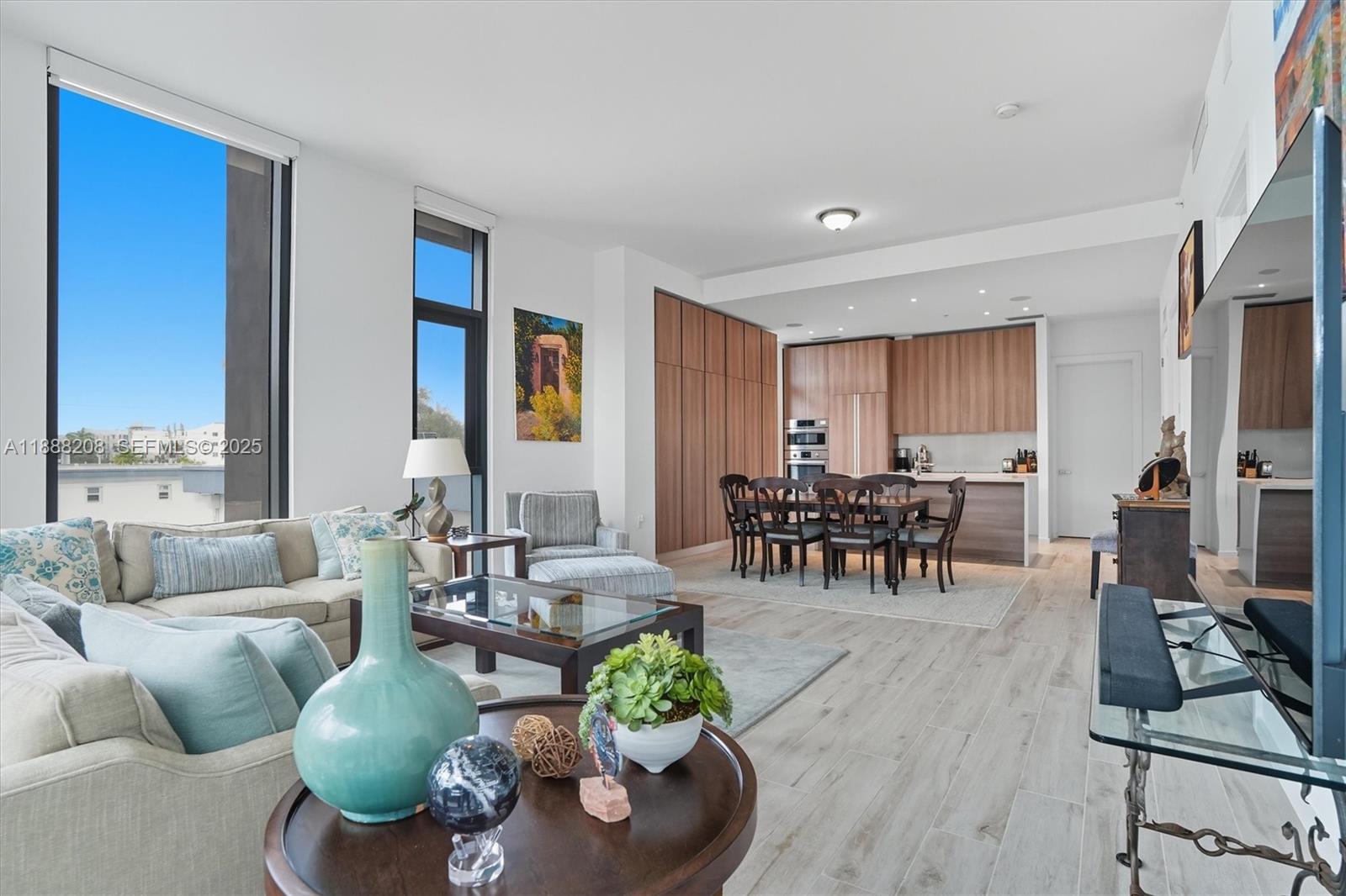 3156 Southwest 27th Avenue, Unit 203 Miami, FL 33133 - Photo 7 of 34 a living room with furniture and a large window