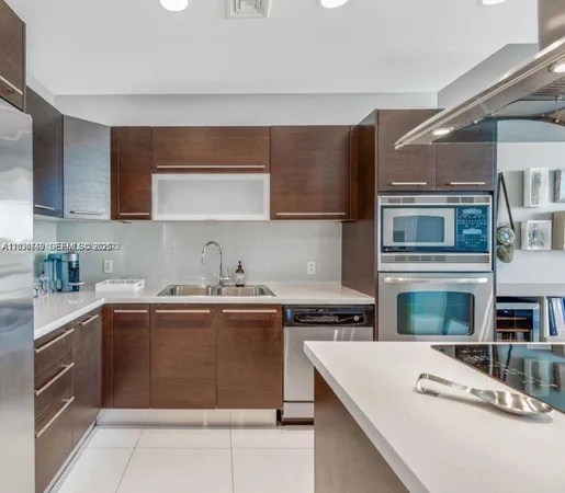 a kitchen with stainless steel appliances granite countertop a stove sink and cabinets