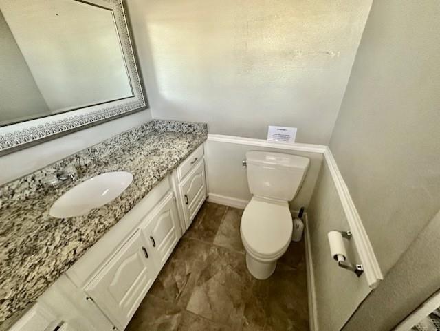 1319 Parker Road St. Paul, TX 75098 - Photo 13 of 19 a bathroom with a granite countertop toilet and a sink
