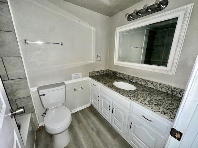 1319 Parker Road St. Paul, TX 75098 - Photo 16 of 19 a bathroom with a granite countertop toilet sink and mirror