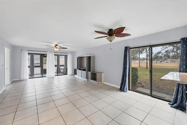a view of entryway with window and a ceiling fan