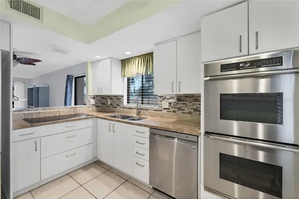 a kitchen with windows and cabinet