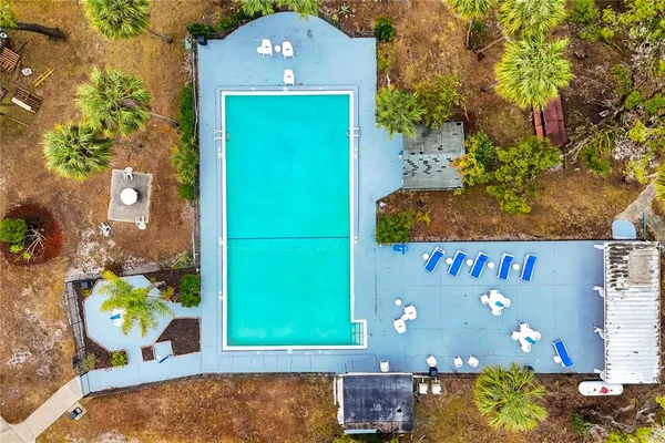 an aerial view of a house with a yard and lake view