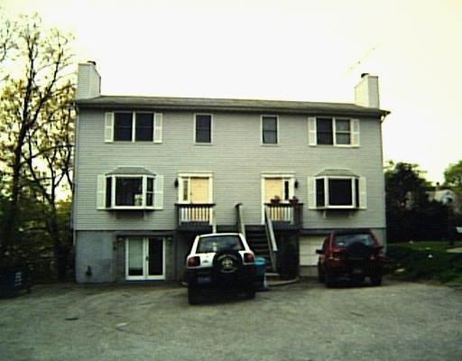 a front view of a house with parking space
