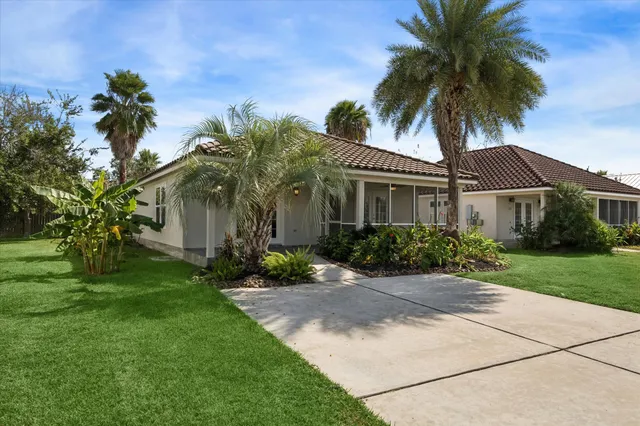 a front view of a house with a garden