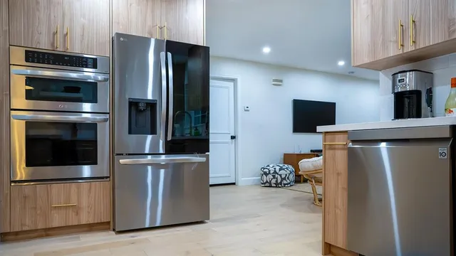 a kitchen with stainless steel appliances and wooden cabinets