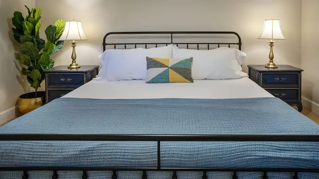 a bedroom with a bed and a night stand