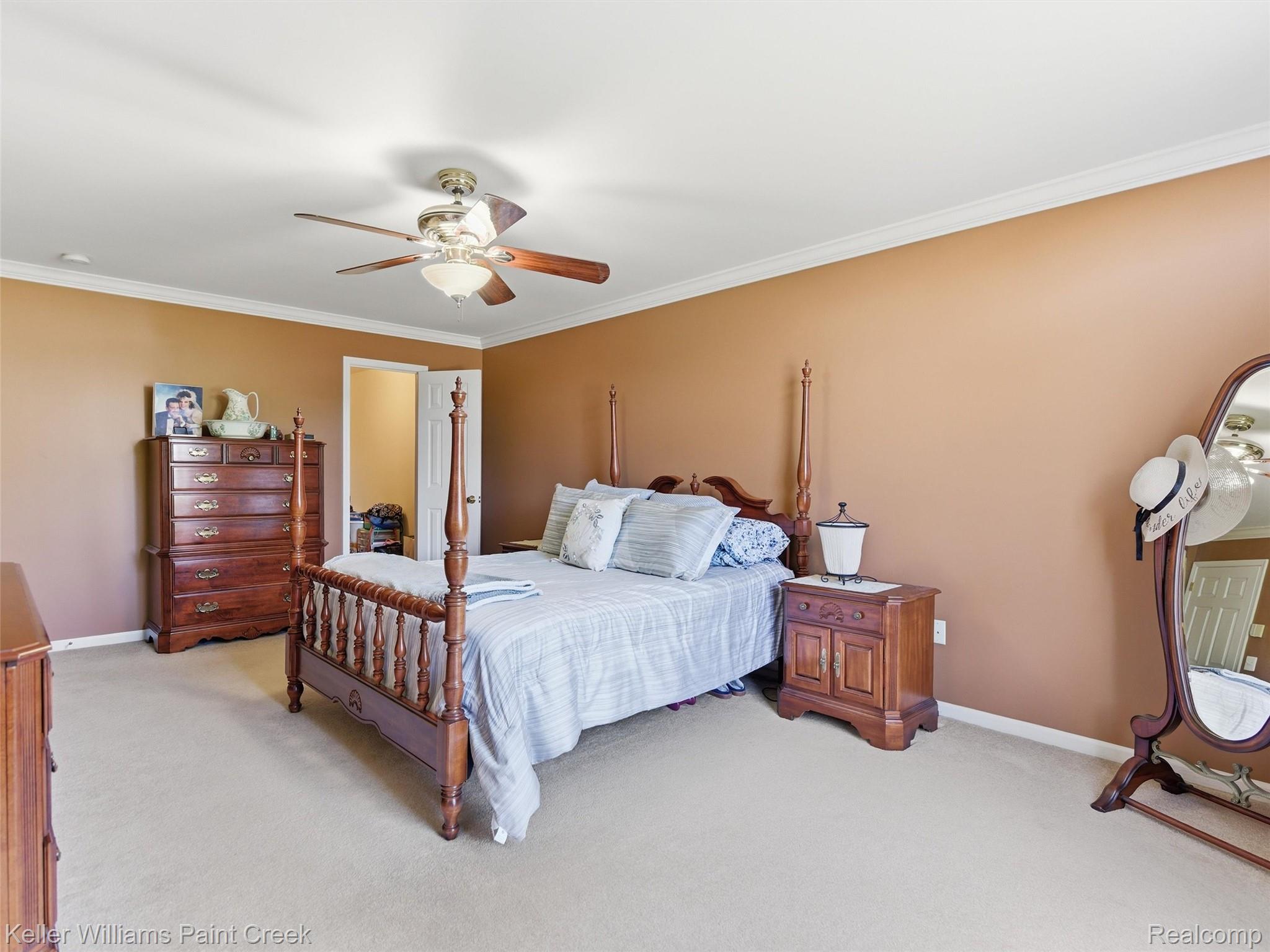 2842 Manorwood Road Troy, MI 48085 - Photo 46 of 72 Carpeted room featuring a ceiling fan with light fixture, crown molding, and a white interior door