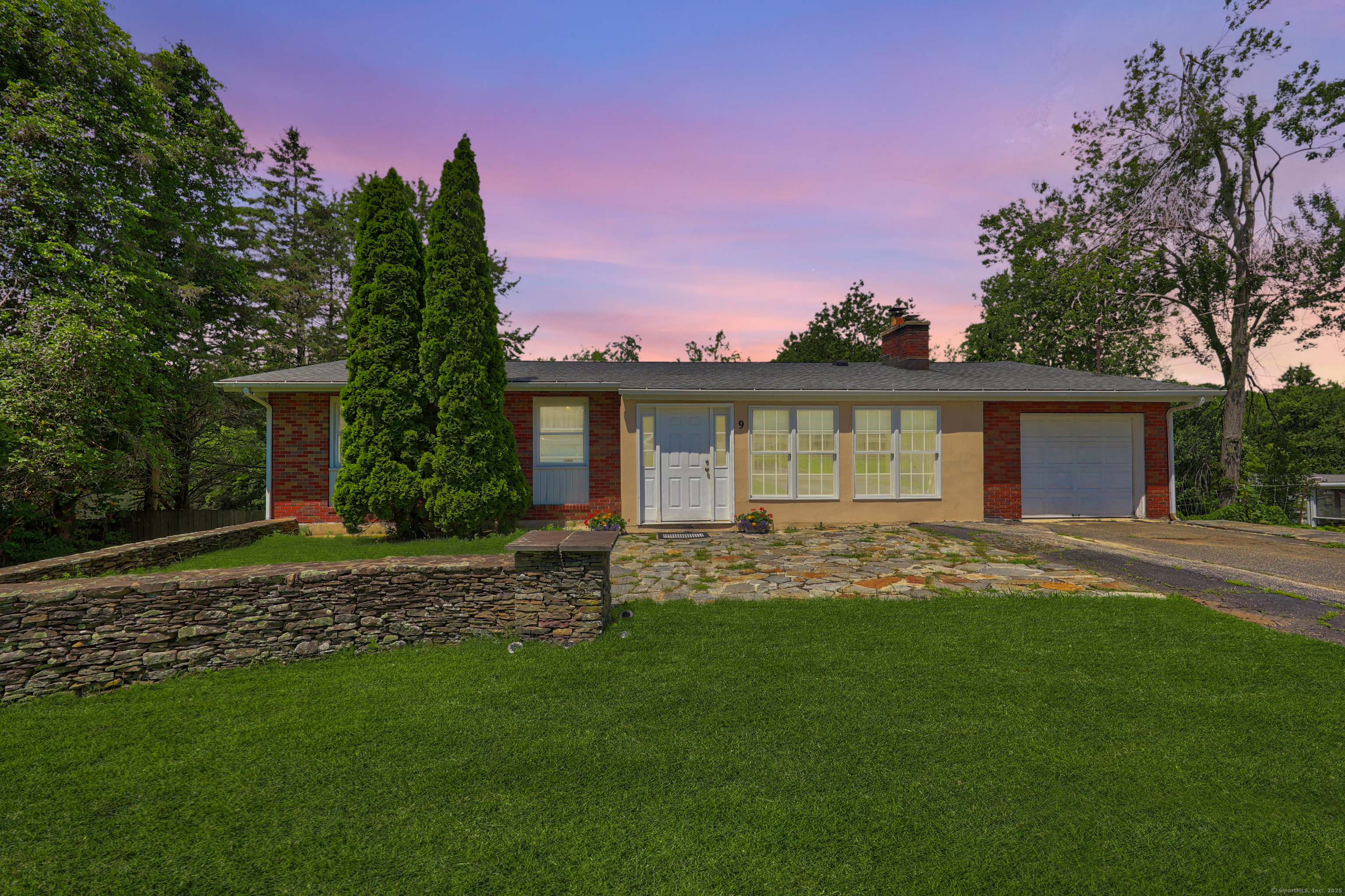 a view of a house with a yard and tree s