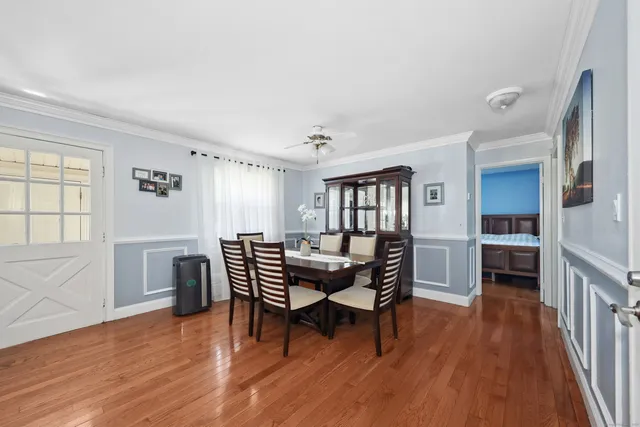 a dining room with furniture and wooden floor
