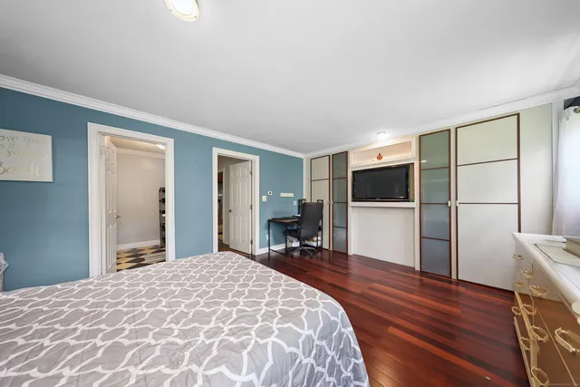 a bedroom with a large bed and a window