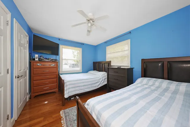 a bedroom with two beds and a window