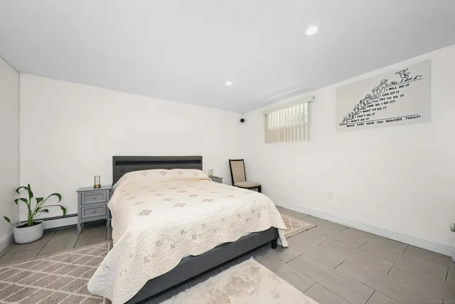 a bedroom with a bed and lamp