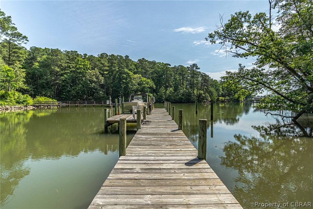 3215 Weems Road Weems, VA 22576 - Photo 17 of 50 a wooden pier with boats in a lake