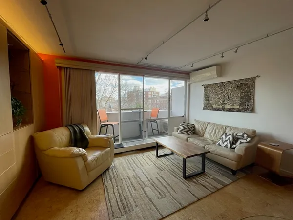 a living room with furniture and a large window