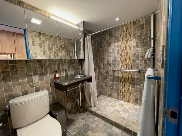 a bathroom with a sink toilet and shower