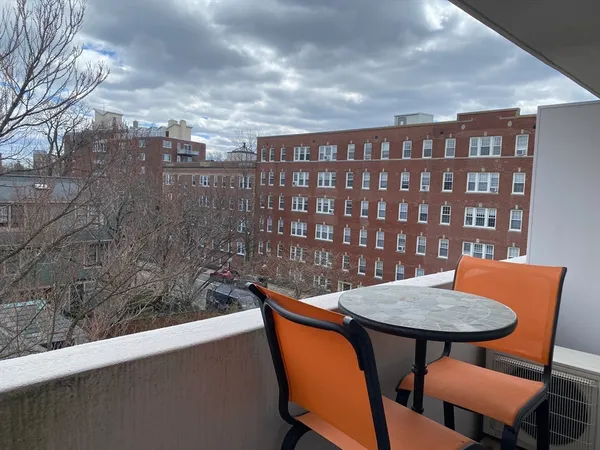 a balcony with a table and chairs
