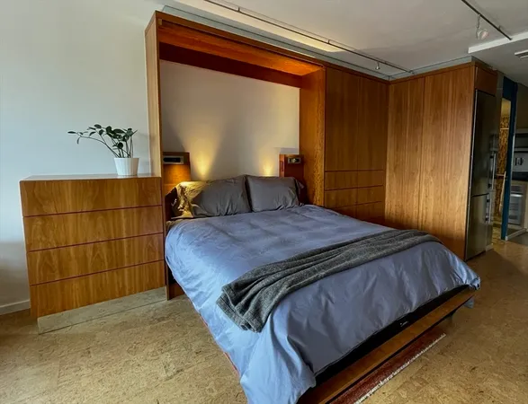 a bedroom with a bed and a mirror