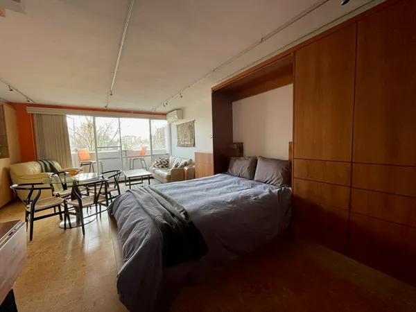 a bedroom with a bed and a large window