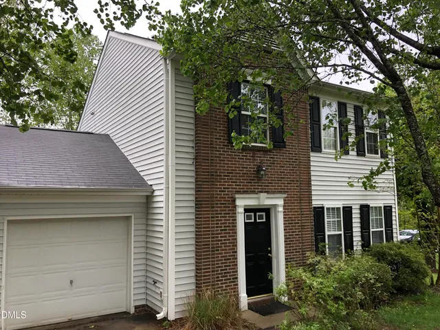 a view of a house with a garage and balcony