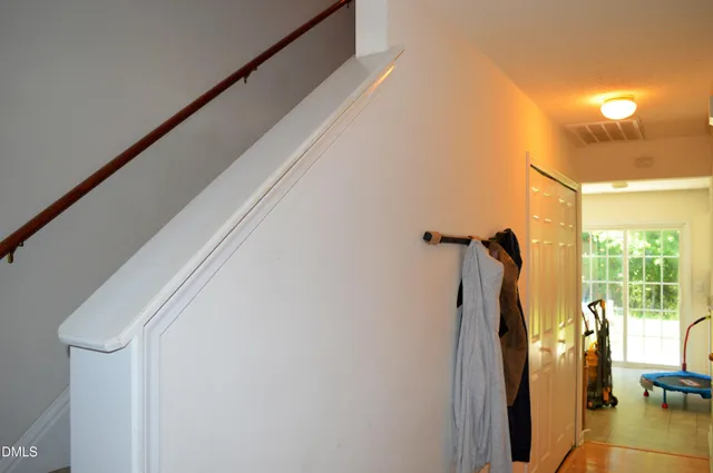 a view of a big room with windows and chandelier fan