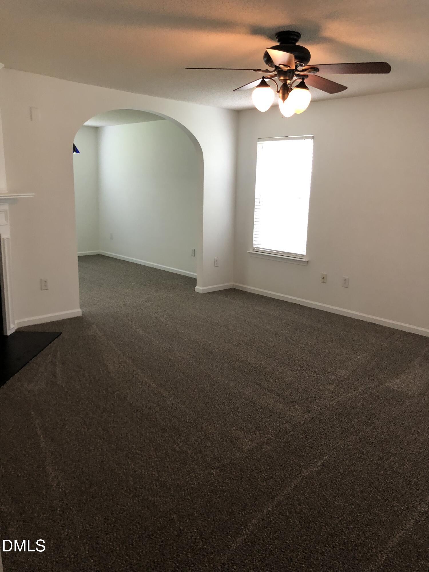 4806 Tapestry Terrace Durham, NC 27713 - Photo 6 of 18 a view of a big room with windows and chandelier fan