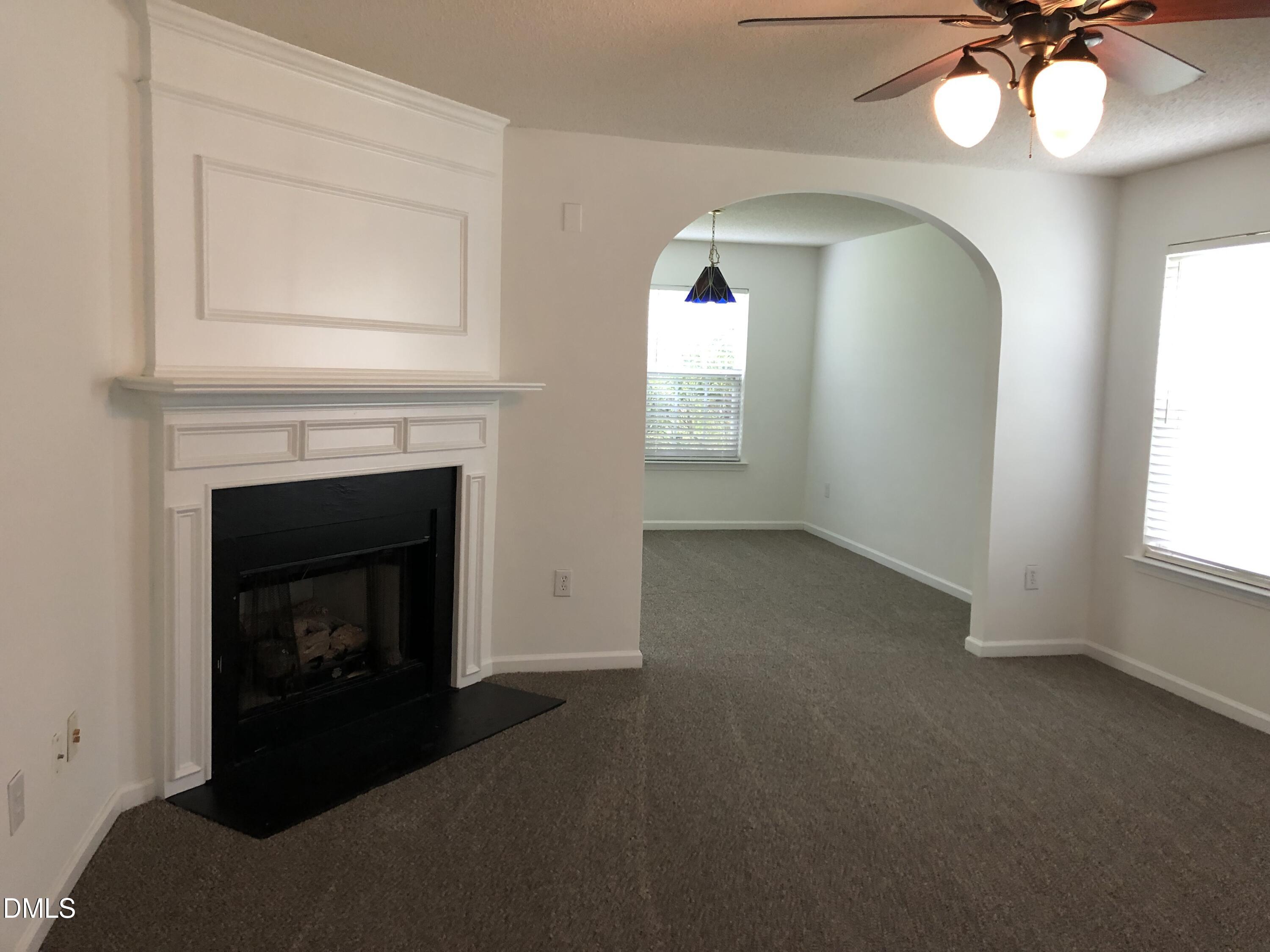 4806 Tapestry Terrace Durham, NC 27713 - Photo 7 of 18 a view of empty room with fireplace and fan