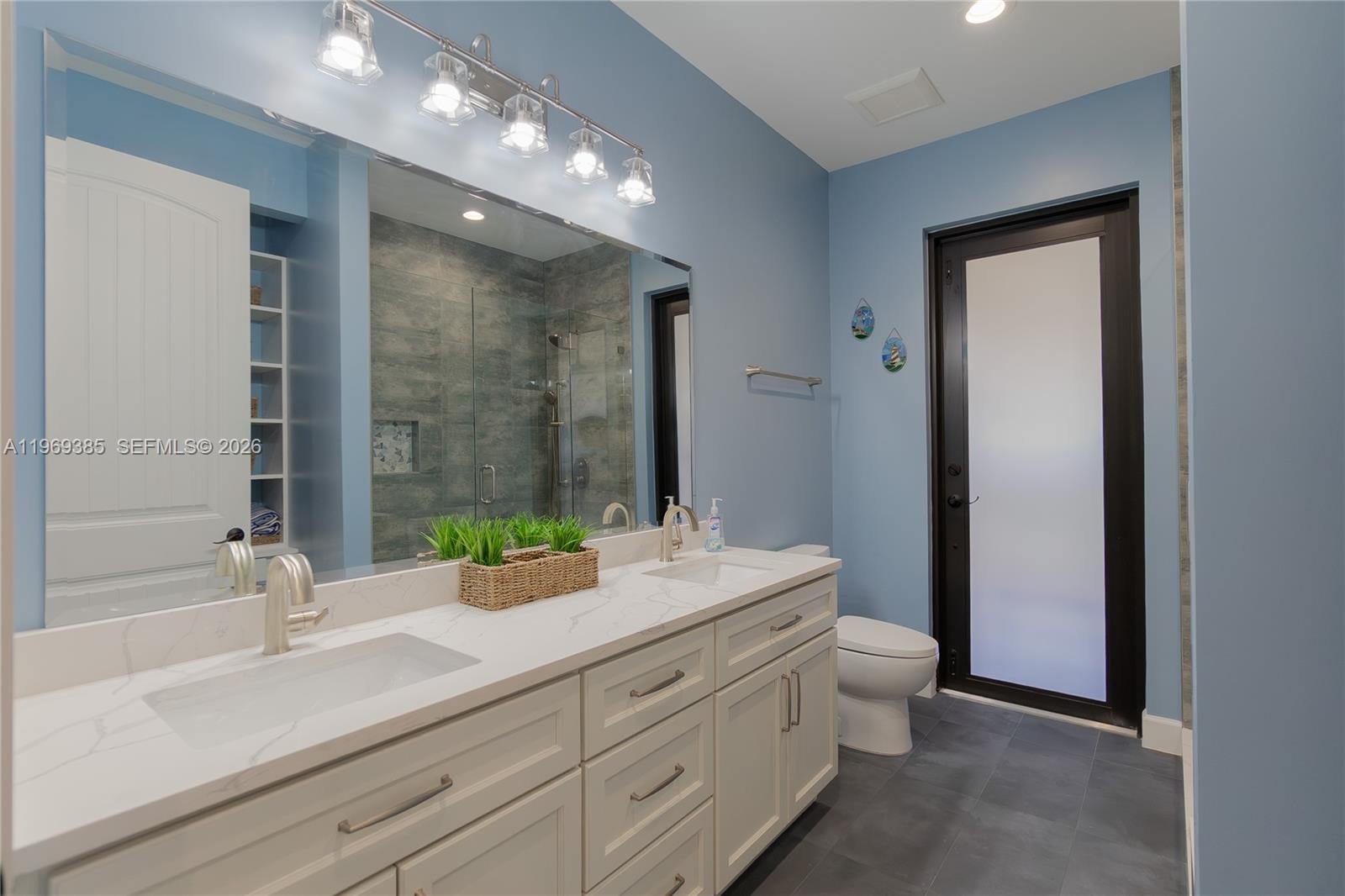 16630 132nd Terrace North Jupiter, FL 33478 - Photo 22 of 31 Beautiful spacious cabana guest bathroom with double vanities and....