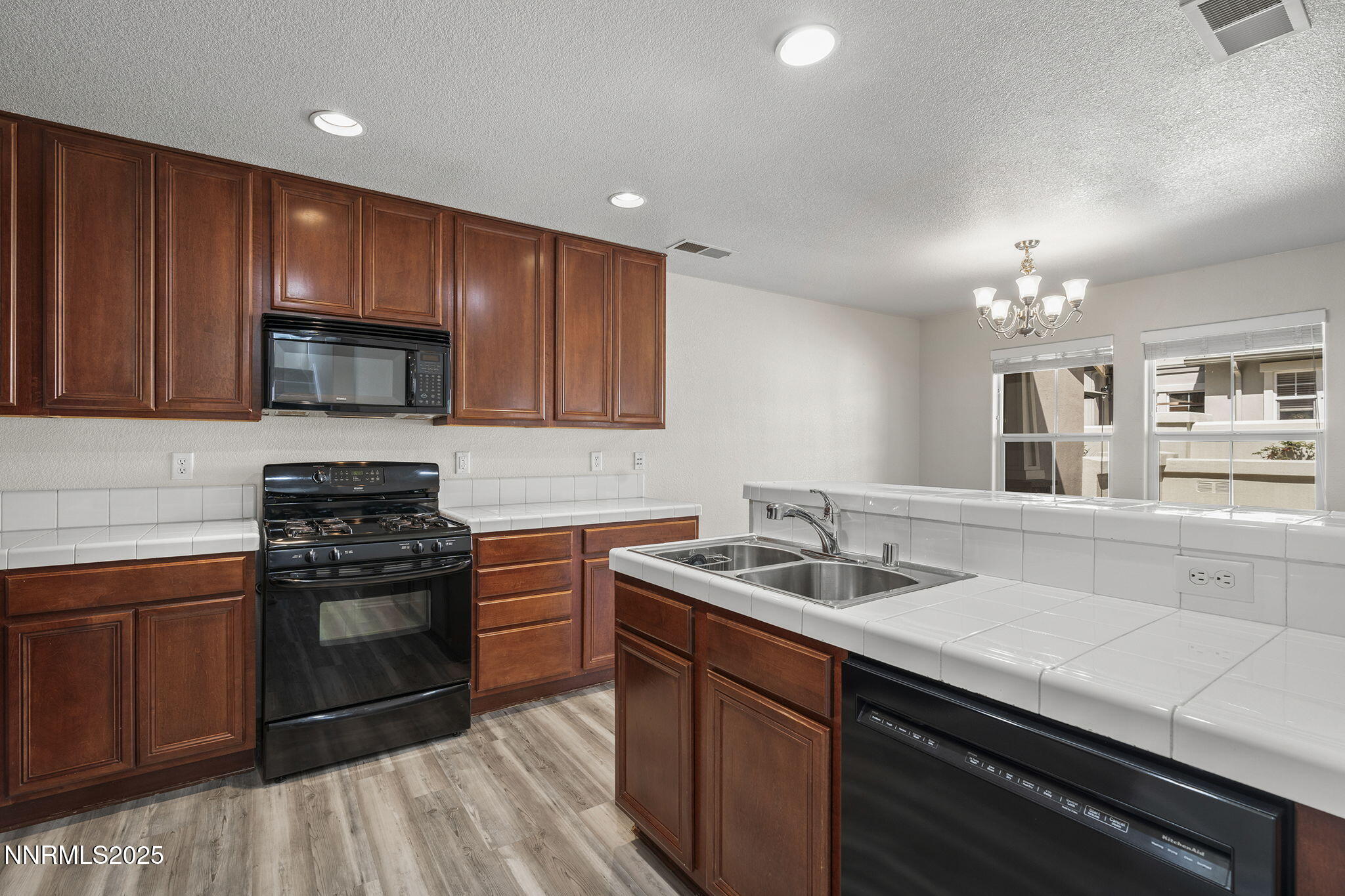 1672 Spring Hill Drive Reno, NV 89523 - Photo 11 of 26 a kitchen with a sink stove and cabinets