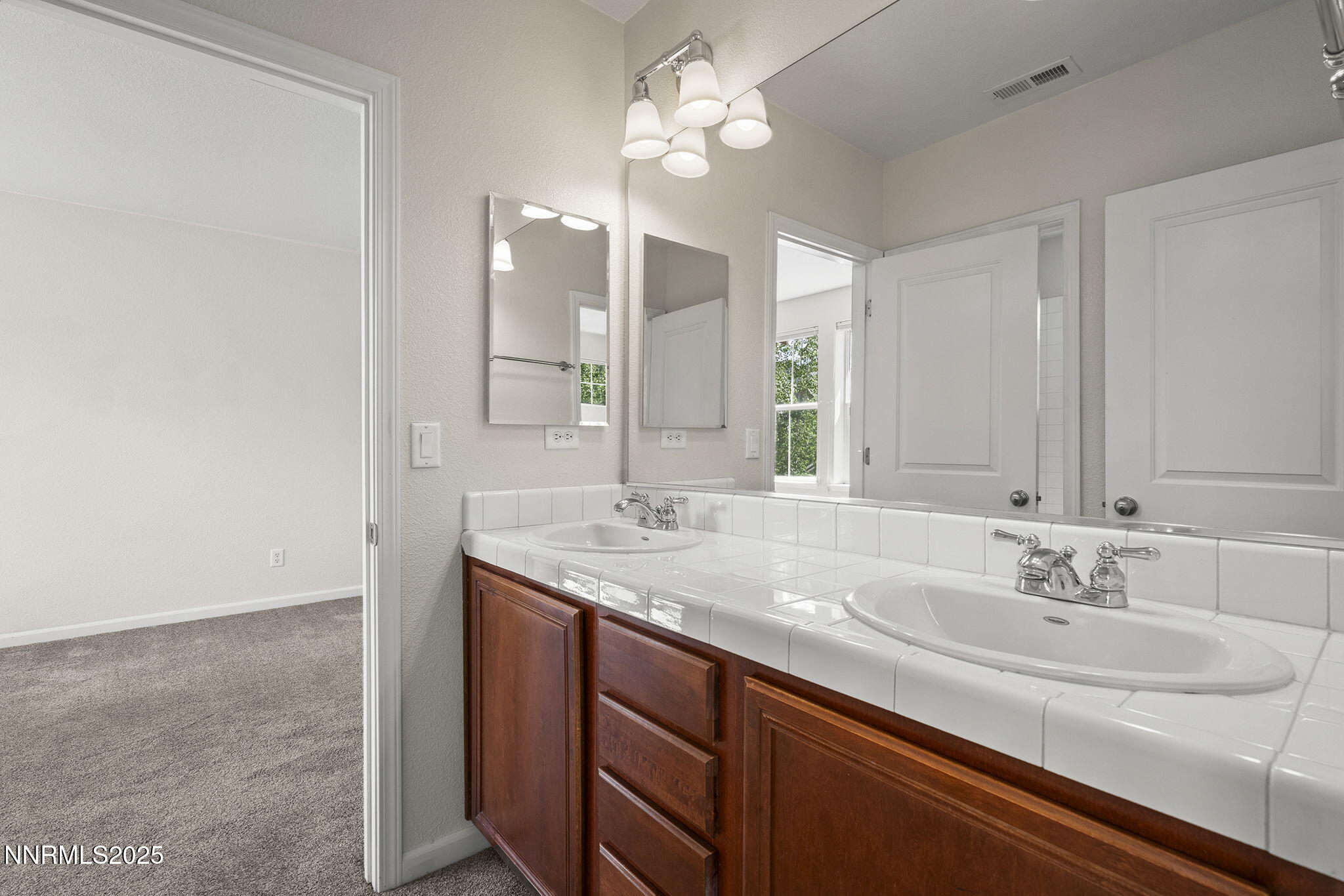 1672 Spring Hill Drive Reno, NV 89523 - Photo 21 of 26 a bathroom with a sink and a mirror
