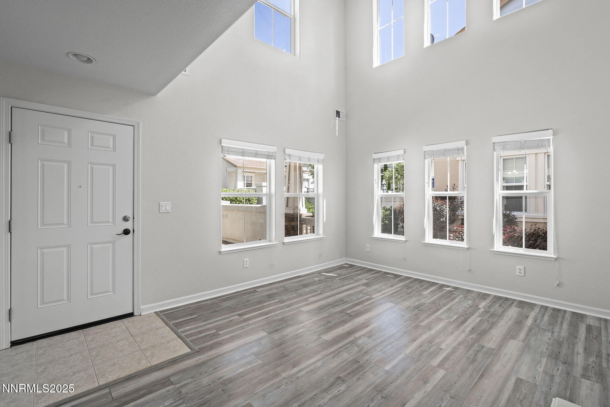 1672 Spring Hill Drive Reno, NV 89523 - Photo 6 of 26 a view of an empty room with a window and wooden floor