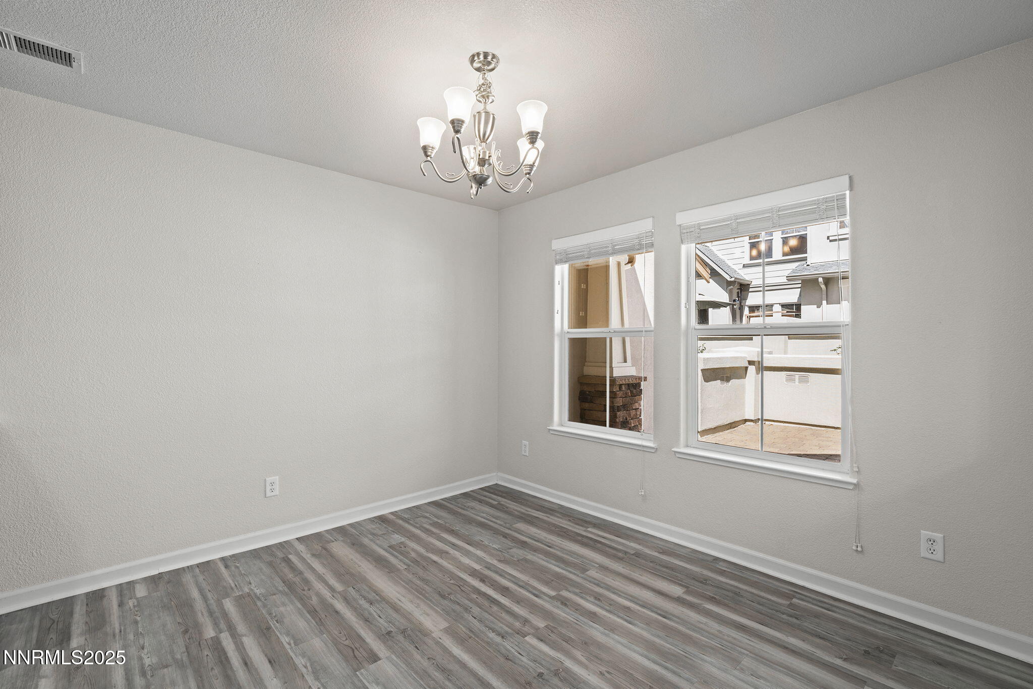 1672 Spring Hill Drive Reno, NV 89523 - Photo 8 of 26 a view of an empty room with a window and wooden floor