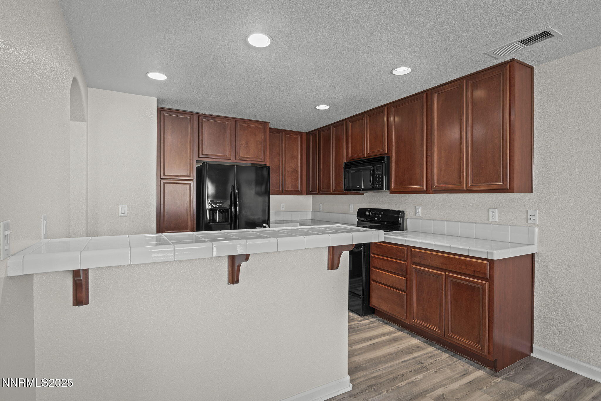 1672 Spring Hill Drive Reno, NV 89523 - Photo 9 of 26 a kitchen with stainless steel appliances granite countertop a sink a stove a refrigerator a microwave and cabinets
