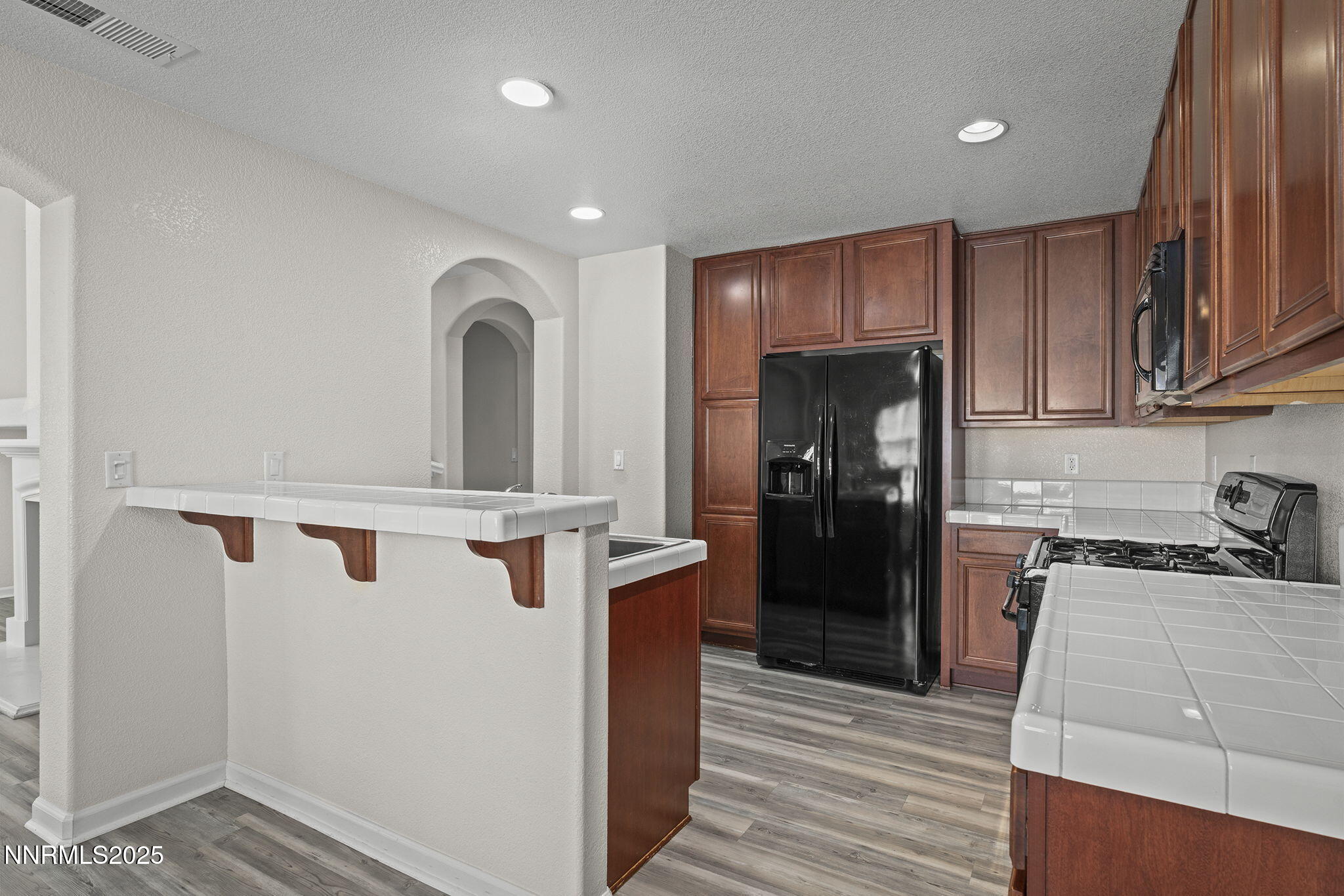 1672 Spring Hill Drive Reno, NV 89523 - Photo 10 of 26 a kitchen with a refrigerator and a sink