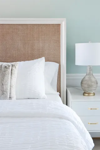 a large white bed in a white room