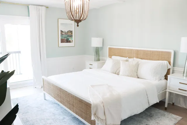 a bedroom with a bed and a painting on the wall